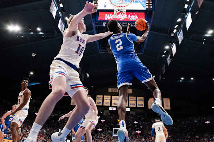 Feb 27, 2024; Lawrence, Kansas, USA; Brigham Young Cougars guard Jaxson Robinson (2) shoots as Kansas Jayhawks guard Johnny Furphy (10) defends during the second half at Allen Fieldhouse. Mandatory Credit: Denny Medley-USA TODAY Sports